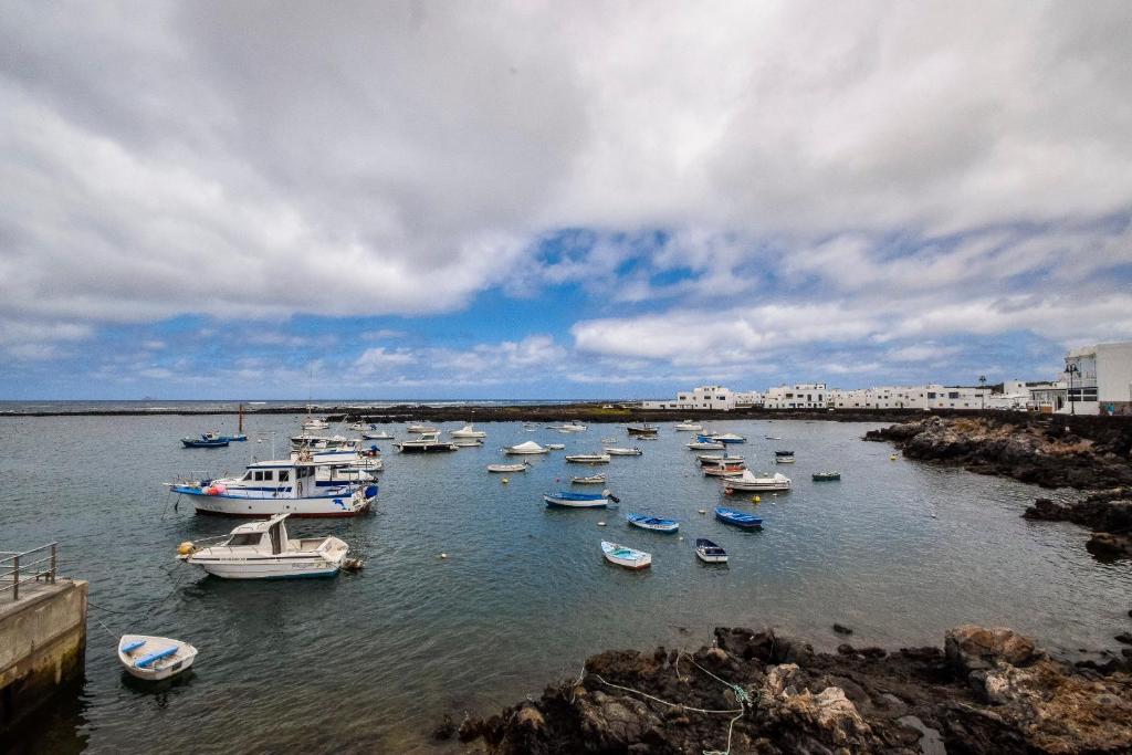 a group of boats are docked in a harbor at Tranquilo y Acogedor Apartamento in Órzola