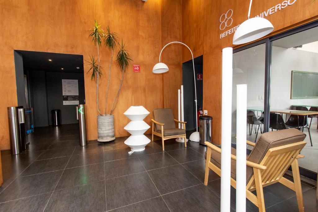 a lobby with chairs and a table in a building at Hotel Centro 433 in Sao Paulo