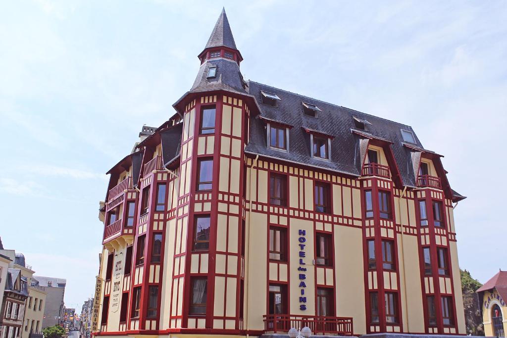 un grand bâtiment avec une tour en haut dans l'établissement Hotel Des Bains, à Granville