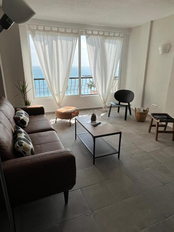 a living room with a couch and a table at Apartamentos La Mar in Altea