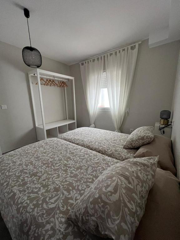 a bedroom with a bed and a window at Apartamentos La Mar in Altea