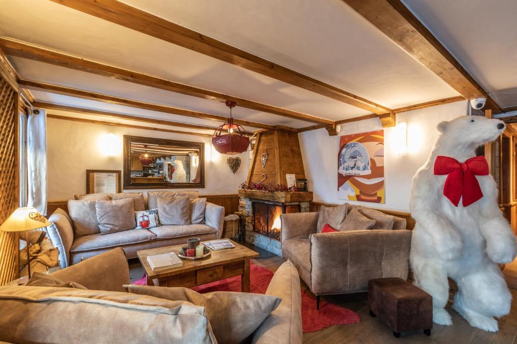 a living room with a large white polar bear standing in a room at Les Monts Charvin in Courchevel