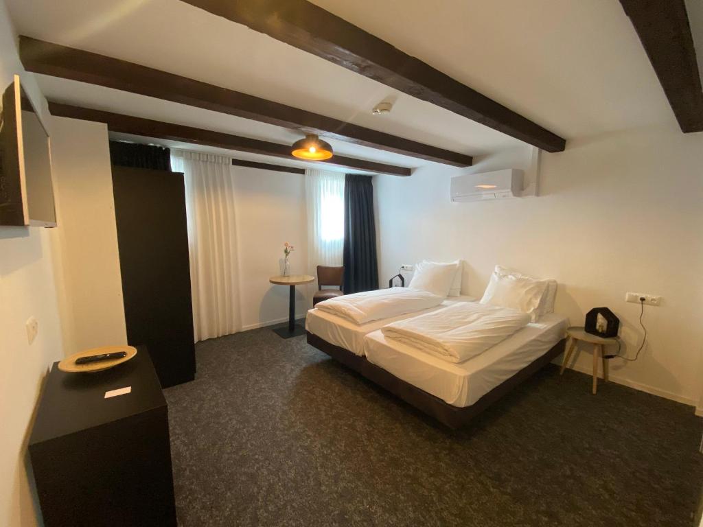 Postel nebo postele na pokoji v ubytování Hotel Restaurant De Stadsherberg
