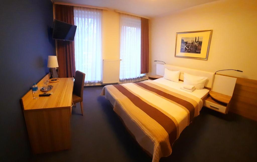 Postel nebo postele na pokoji v ubytování Hotel Arsenał