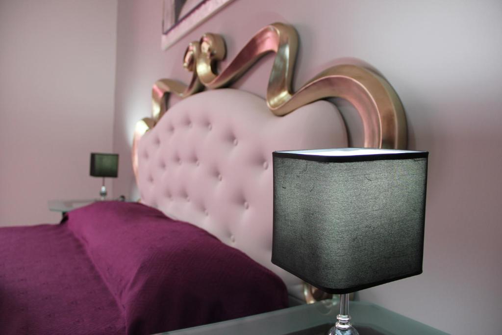 a bedroom with a pink bed with a heart shaped headboard at B&B Trapani Bedda in Paceco