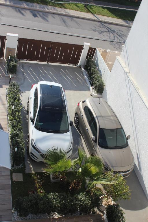 two cars parked next to each other in a parking lot at Le casette in Monopoli