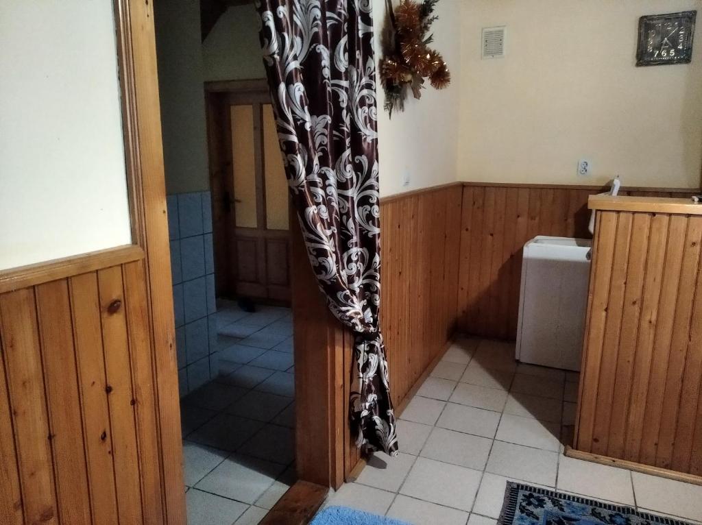 a bathroom with a shower curtain in a room at Радуга in Podobovets