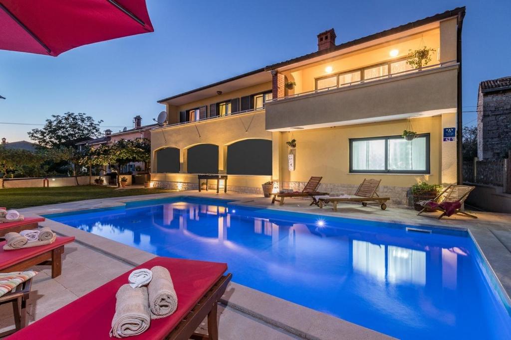 a swimming pool in the backyard of a house at Villa Leona in Čabrunići