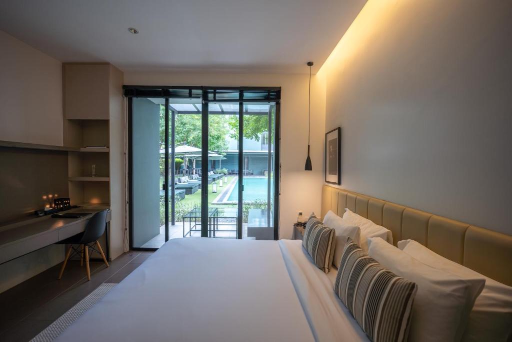 A warm-lit bedroom opening directly onto the hotel courtyard.