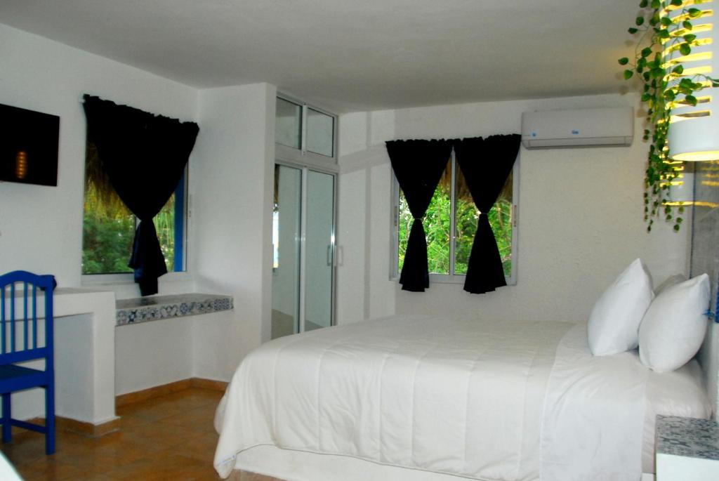 Postel nebo postele na pokoji v ubytování Nuovo Hotel Playa Catalina