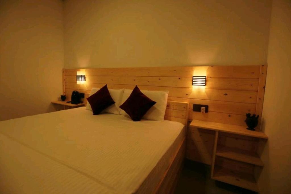 Postel nebo postele na pokoji v ubytování Wingate Homestay