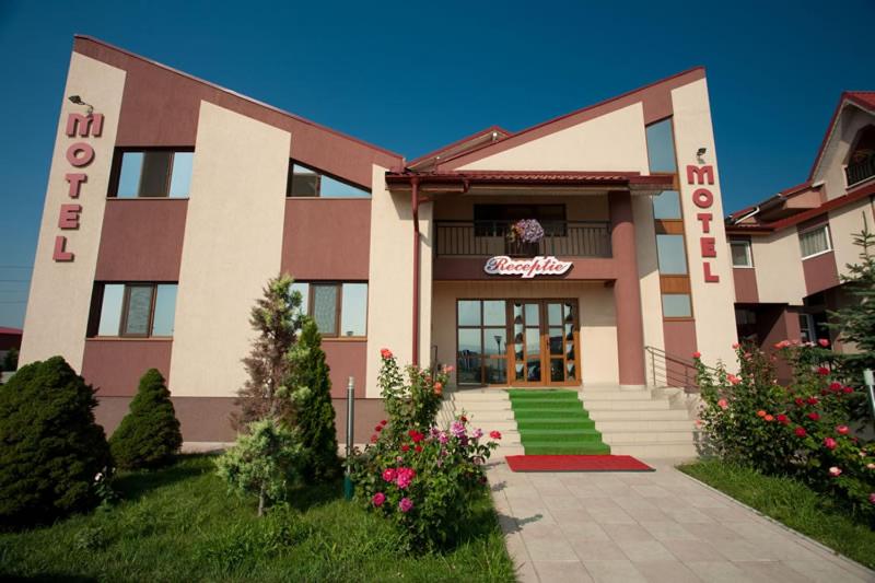 a building with a sign on the front of it at Hotel Levisticum in Bacău