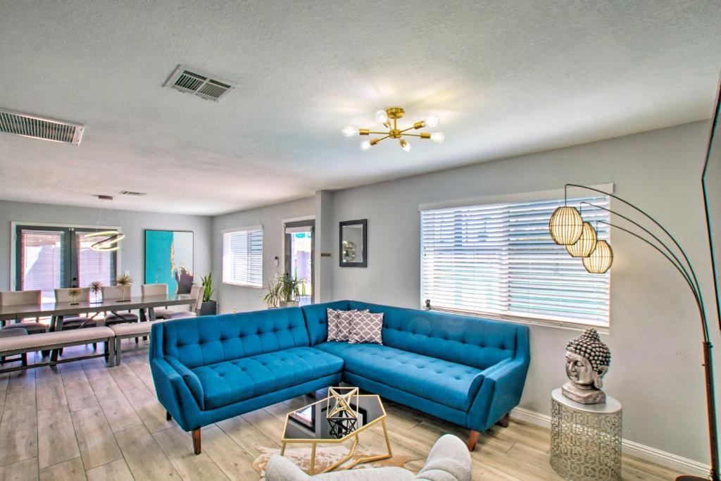 a living room with a blue couch and a table at Charming Phoenix Home with Patio about 3 Miles to Dtwn! in Phoenix