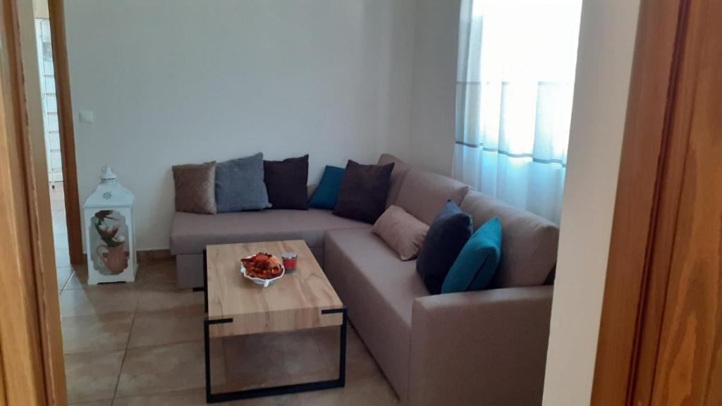 a living room with a couch and a coffee table at ILIANA.APARTMENTS in Kardamaina