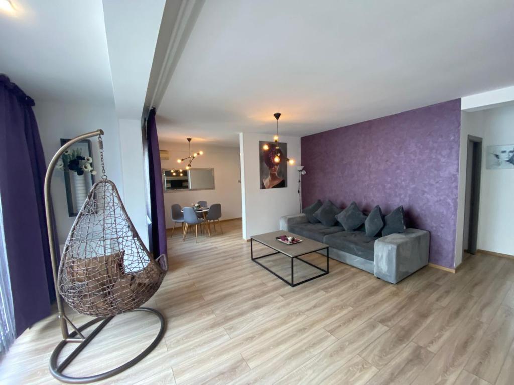 a living room with a couch and a table at Apartament Ella T8 in Mamaia Sat/Năvodari