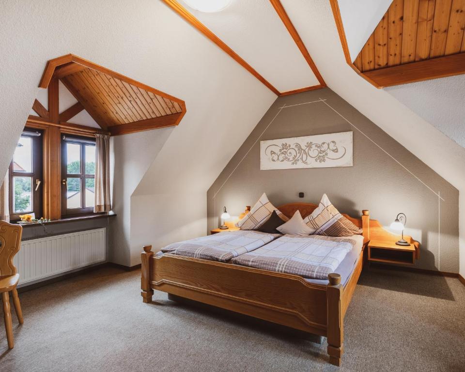 a bedroom with a bed in a attic at Fremden- und Monteurzimmer "Zum Ochsen" in Flieden