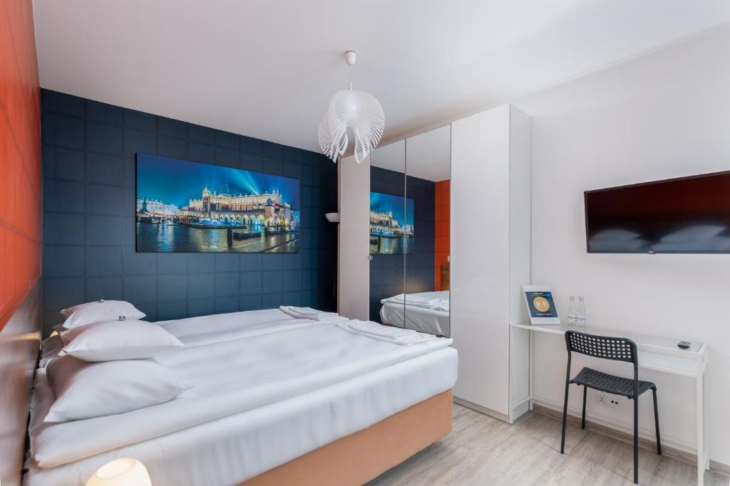 een slaapkamer met een groot wit bed en een stoel bij Apartament Mateo in Krakau