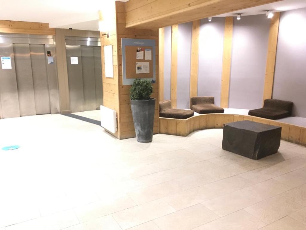 a lobby with two couches and a table in a building at Les Balcons de Bellevarde in Val-d'Isère