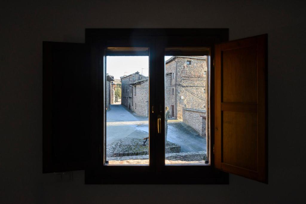 an open window with a view of a street at UNDUESINA Albergue Undués de Lerda in Undués de Lerda