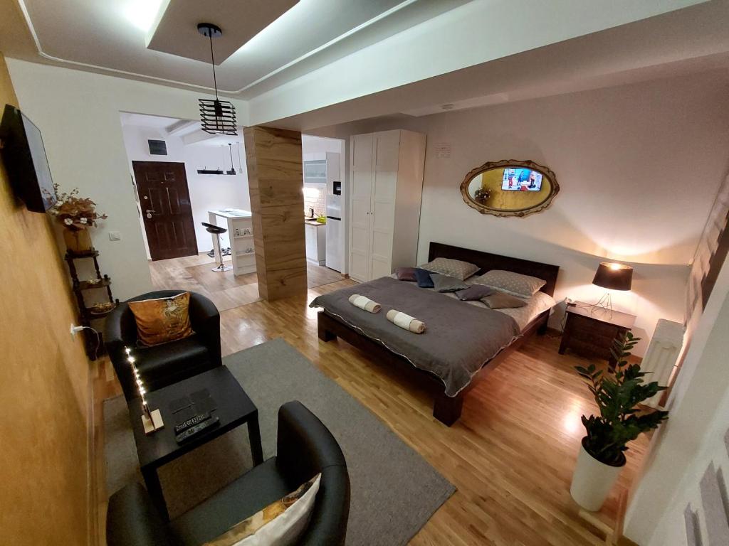 a bedroom with a bed and a living room at Room 23 in Belgrade