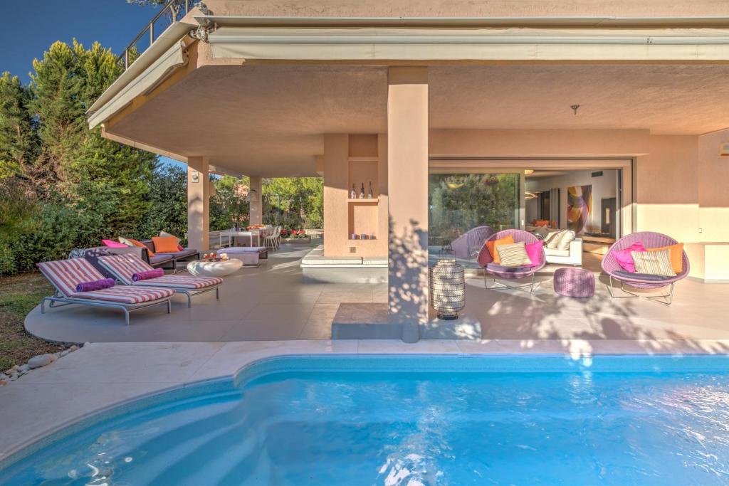 a swimming pool in a backyard with a house at Luxurious Villa Philoxenia in Lagonissi