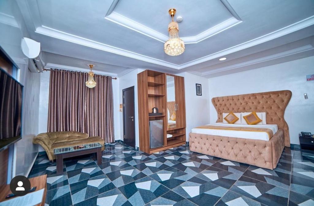 a bedroom with a bed and a checkerboard floor at 247 Luxury Hotel in Lekki