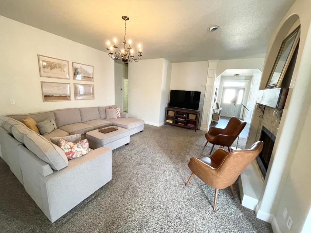 a living room with a couch and a tv at Bike in Bike out Coler The Trail House in Bentonville