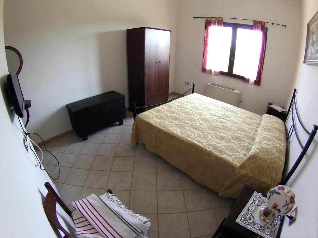 Postel nebo postele na pokoji v ubytování B&B Su Tintillu