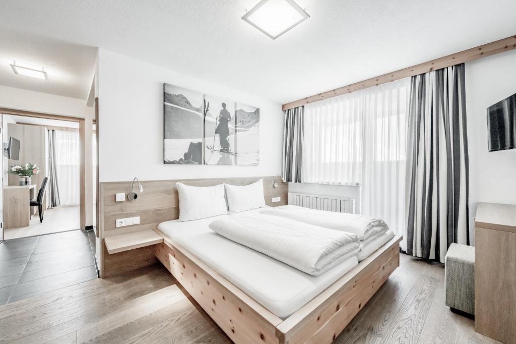 Postel nebo postele na pokoji v ubytování Sporthotel Olymp