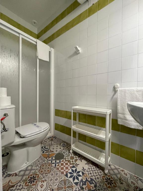 a bathroom with a toilet and a sink at HOSTAL LA CRUZ 1872 in Chipiona