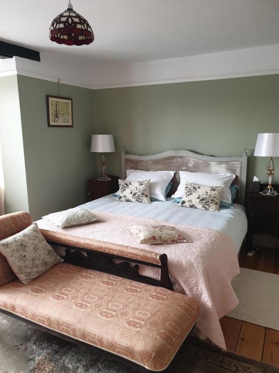a bedroom with a large bed with a pink blanket at Harry's bed and breakfast in Cambridge