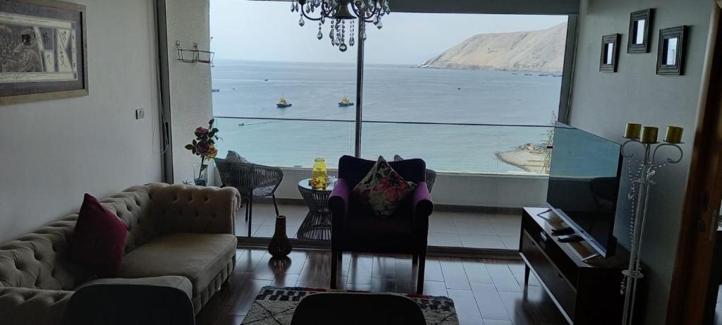 a living room with a view of the ocean at Capital 01 in Iquique