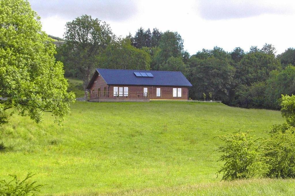 a house in a field with a green field at Cottage, Manorhamilton in Manorhamilton