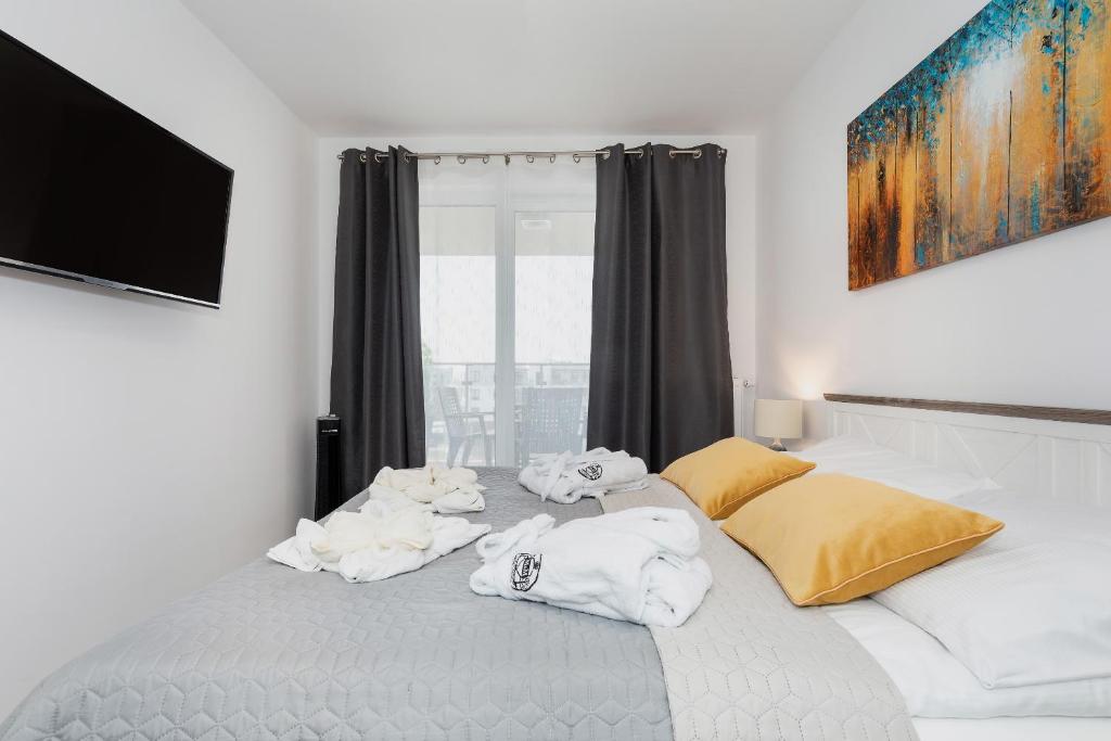 sypialnia z łóżkiem z ręcznikami w obiekcie Apartaments SWEET HOME AQUA & SPA w Kołobrzegu
