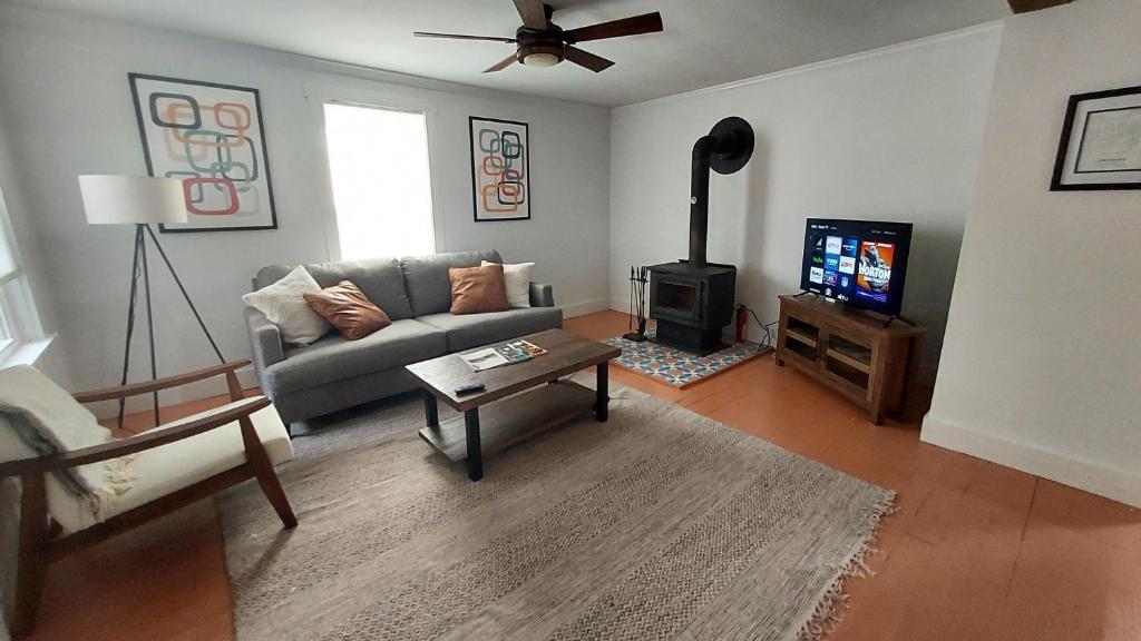 a living room with a couch and a television at Lewisburg duplex in Lewisburg
