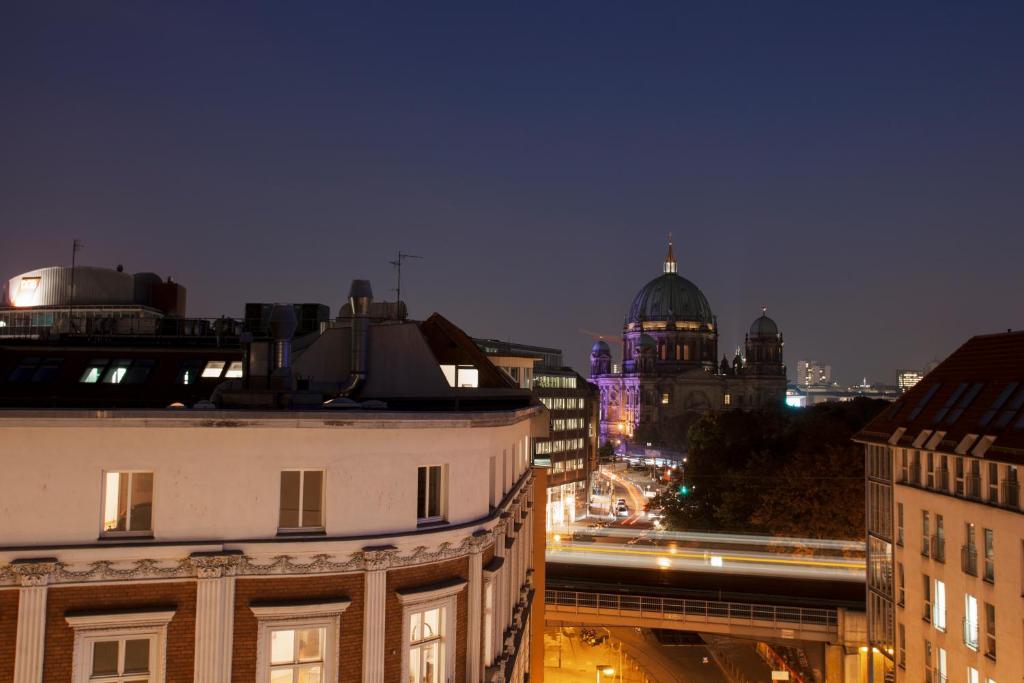 a view of a city at night with buildings at Monbijou Hotel in Berlin