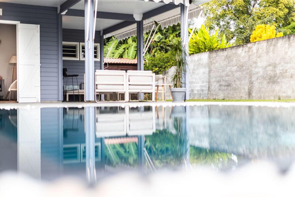 a swimming pool in front of a house at La Villa Daminou, Basse-Terre, Guadeloupe in Lamentin