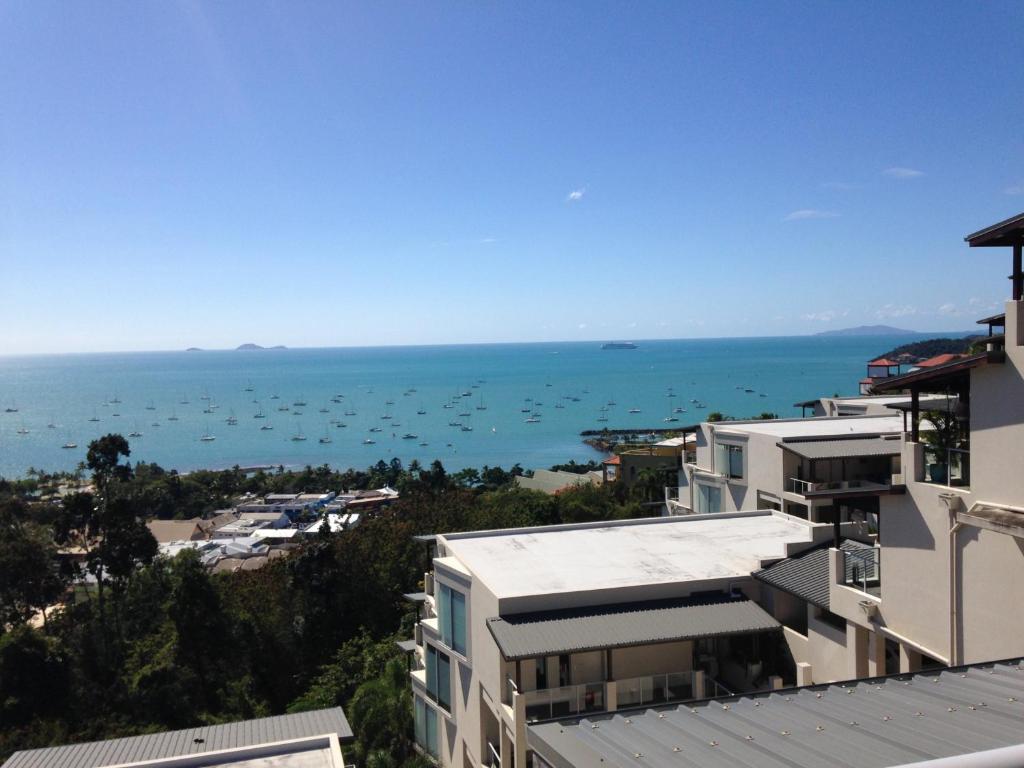 a city with a lot of houses and boats on the water at Whitsunday Reflections in Airlie Beach