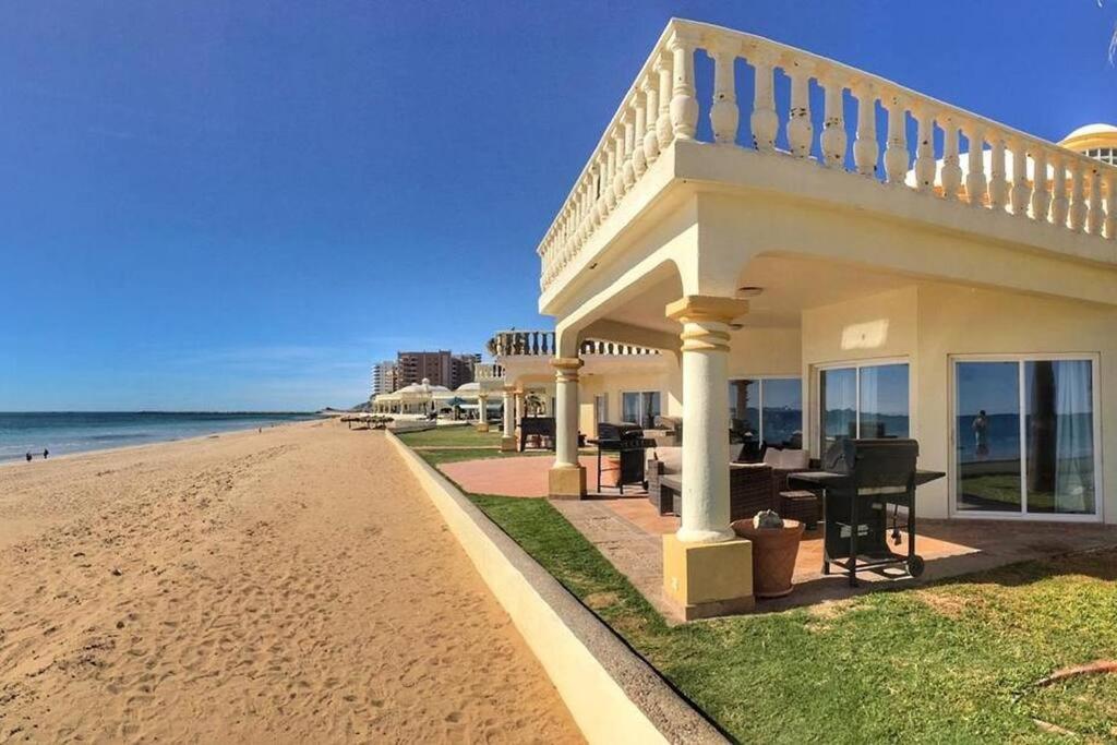 a house on the beach next to the ocean at Gorgeous Beachfront Villa Rocky point, Sandy Beach in Puerto Peñasco