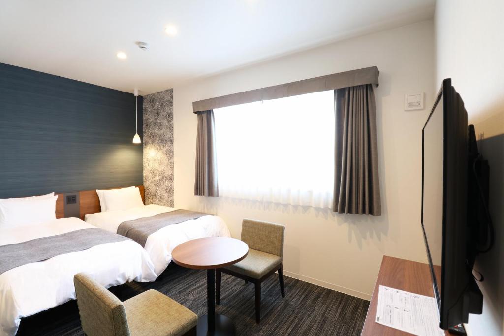 Postel nebo postele na pokoji v ubytování M's Hotel Nijojo Oike