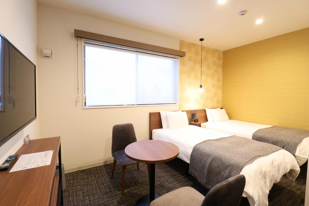 Postel nebo postele na pokoji v ubytování M's Hotel Nijojo Oike