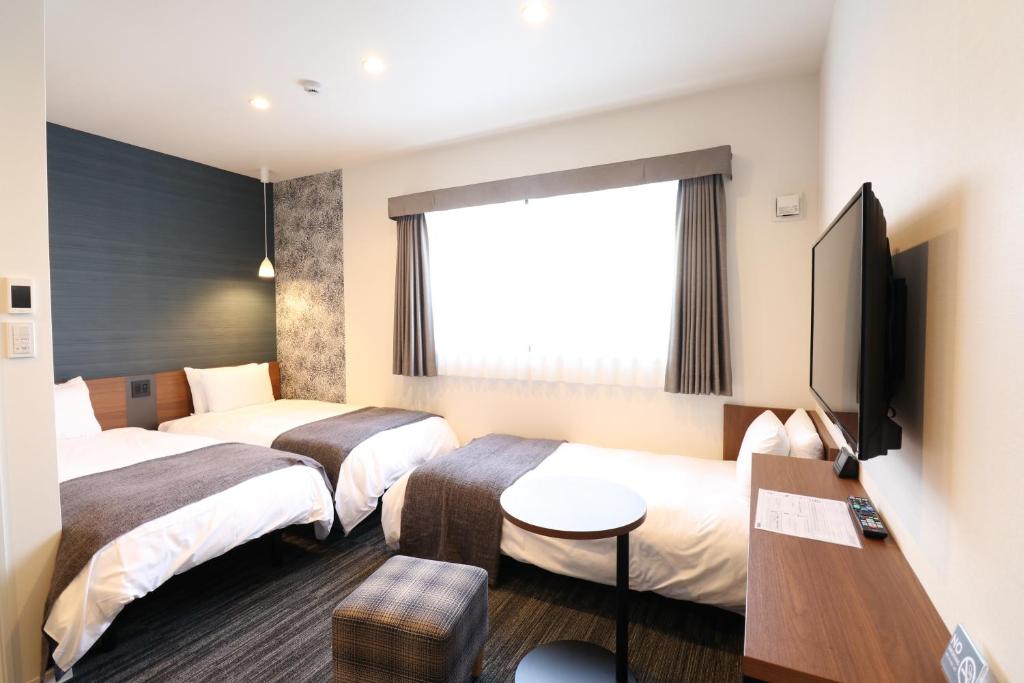 Postel nebo postele na pokoji v ubytování M's Hotel Nijojo Oike