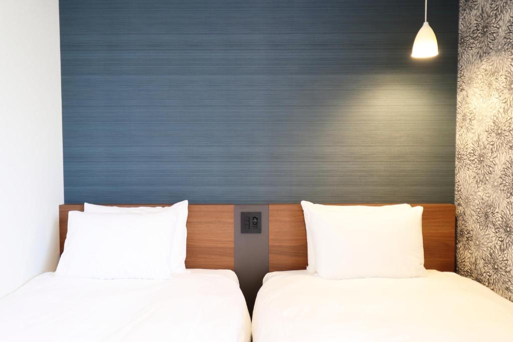 Postel nebo postele na pokoji v ubytování M's Hotel Nijojo Oike