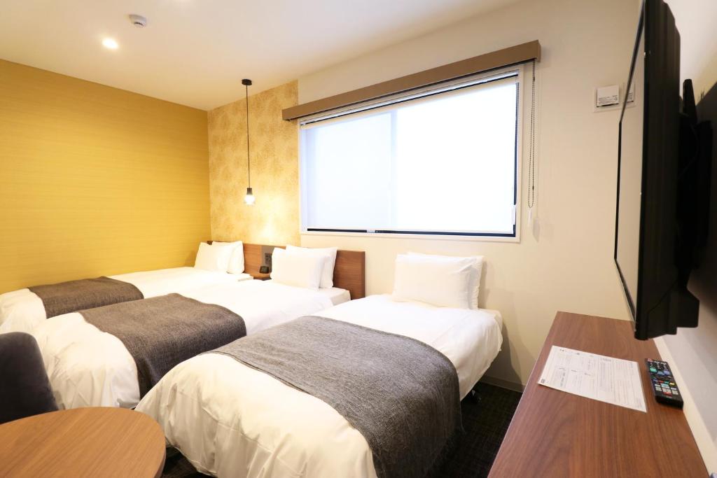 Postel nebo postele na pokoji v ubytování M's Hotel Nijojo Oike