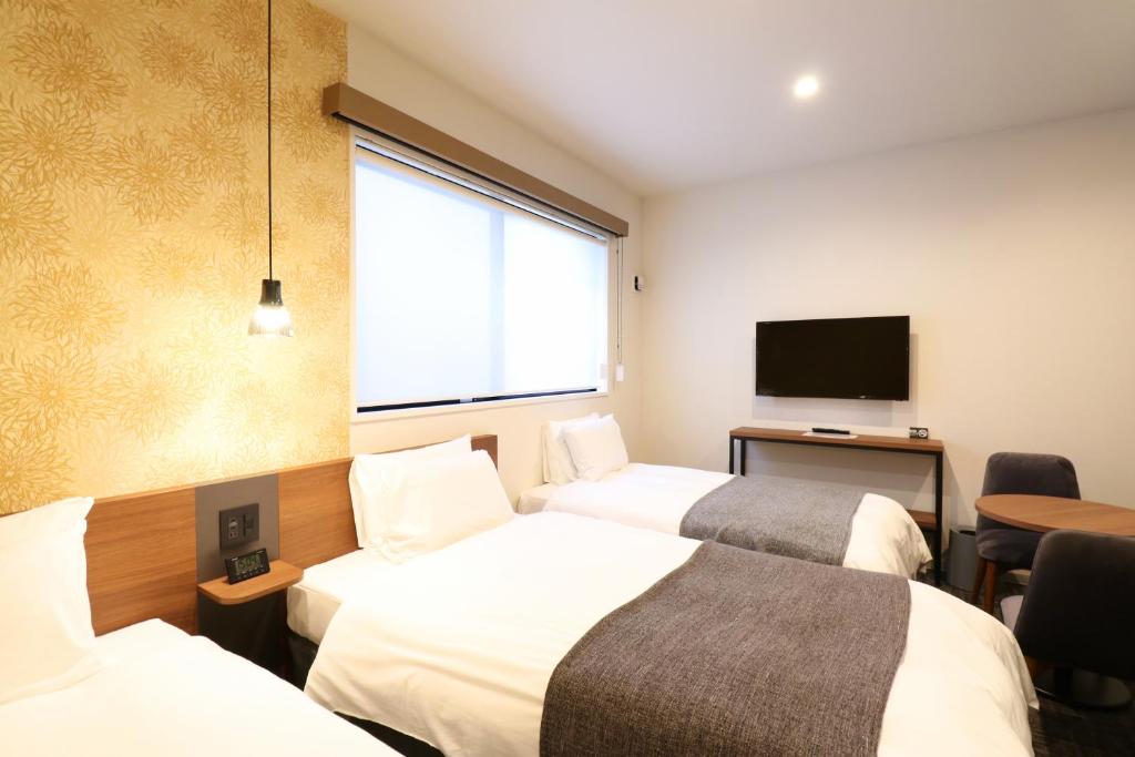 Postel nebo postele na pokoji v ubytování M's Hotel Nijojo Oike