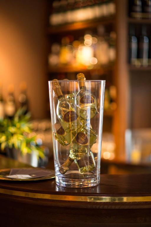 a glass filled with rocks on a table at Monbijou Hotel in Berlin