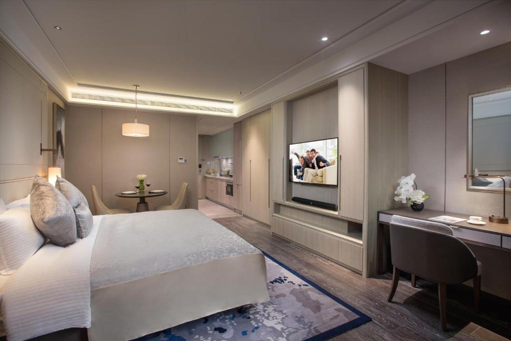 Letto o letti in una camera di Ascott Harmony City Nantong