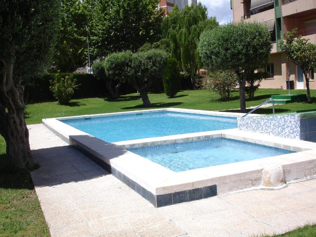 a swimming pool in the middle of a yard at Los Olivos - Zand Properties in Benidorm