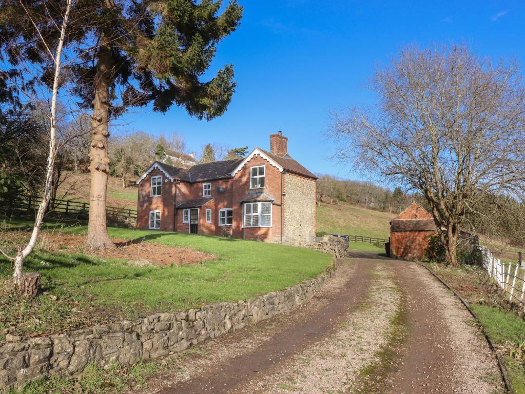 an old house on a hill with a dirt road at Crews Hill House in Worcester