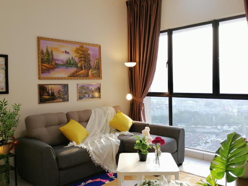 a living room with a couch and a table at Astetica Residences @ Seri Kembangan in Seri Kembangan